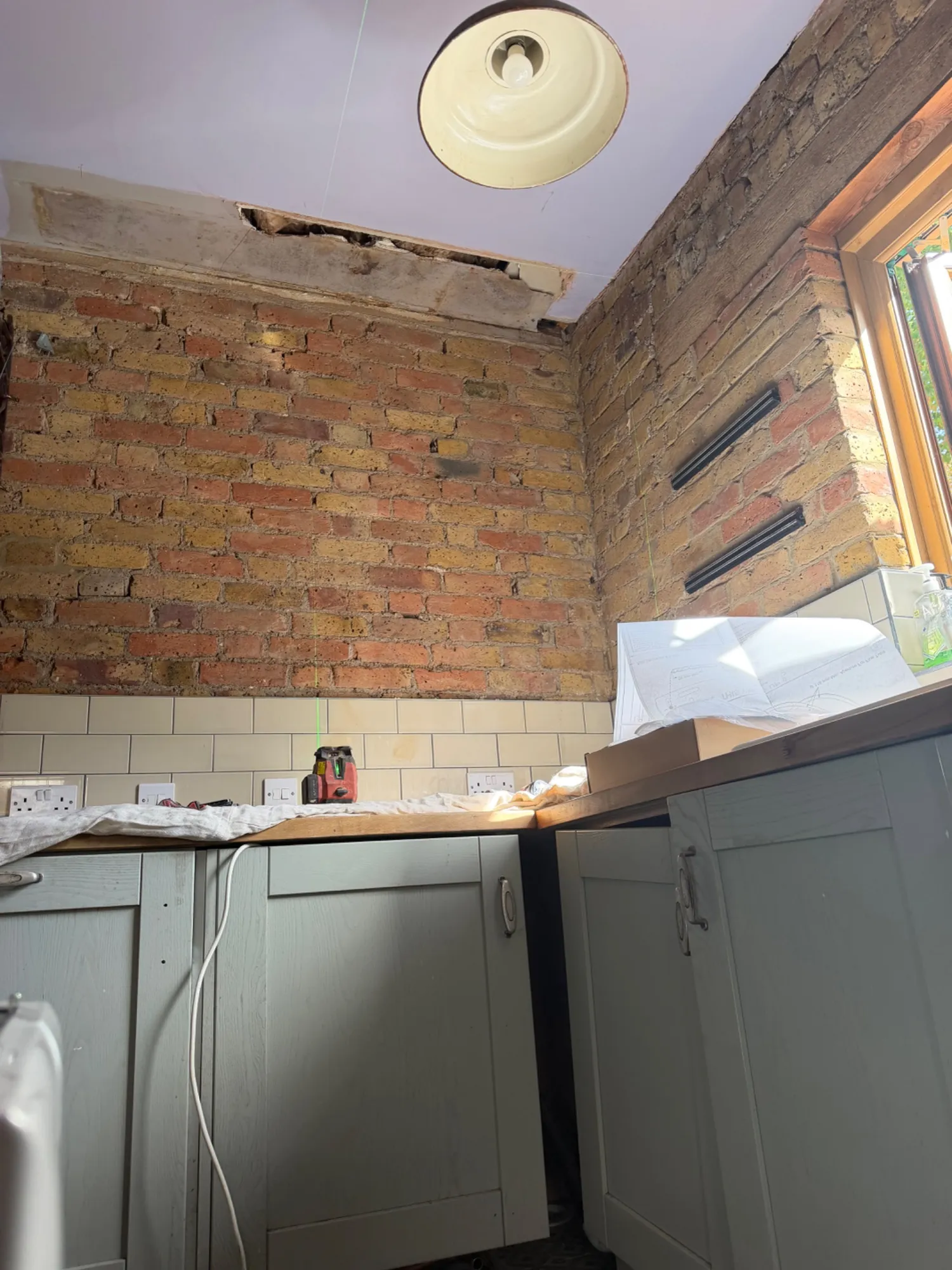 Wall cleared after the cupboard was removed for the new combi boiler in Solihull